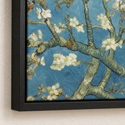 Almond Blossom — black floater frame corner detail mockup showing matte canvas texture and shadow gap