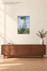 Woman with a Parasol · 16 × 24 inches · Stretched canvas · artwork only · room mockup · approximate scale against 60-inch sideboard